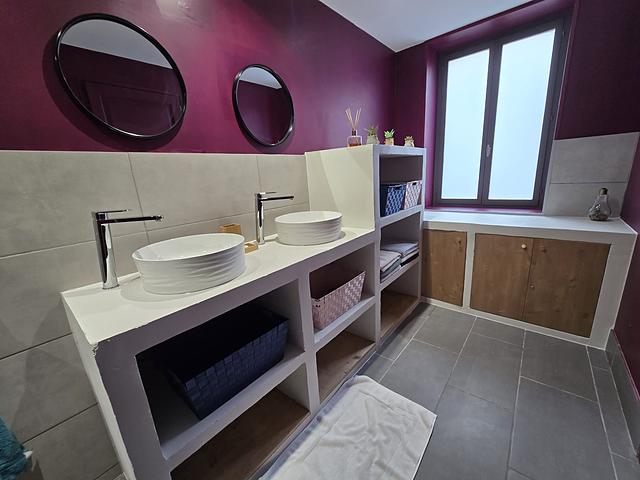 Salle de bain avec double vasque et meuble de rangement